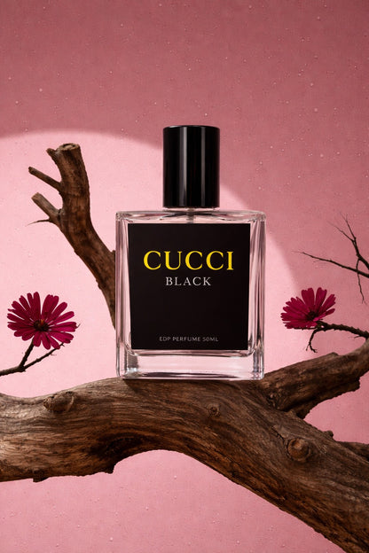 Cucci Black perfume bottle on a branch with pink flowers and background