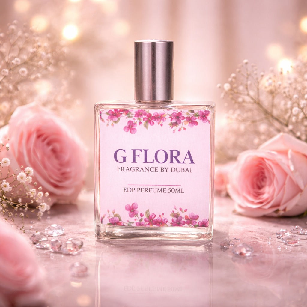 Perfume bottle labeled 'G Flora' with pink floral design on a soft focus background with roses.