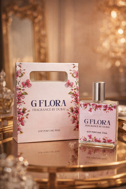 G Flora perfume bottle and packaging on a reflective surface with a blurred background