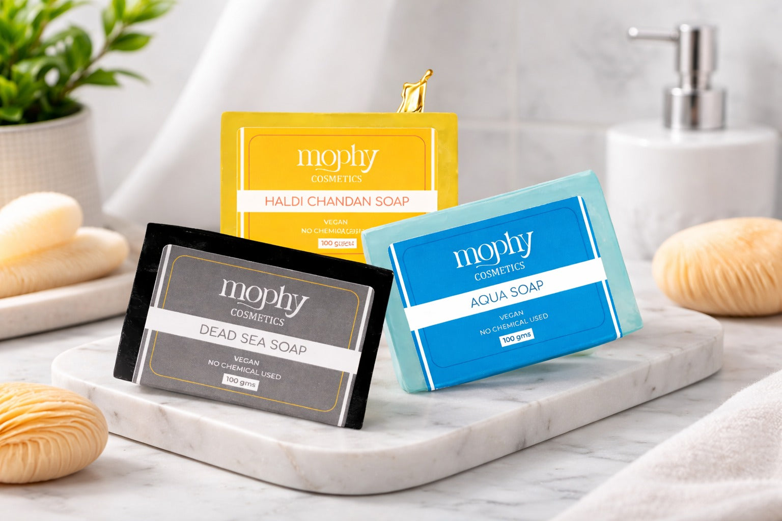 Mophy Cosmetics soap packages on a marble tray with a plant and soap bars in the background.