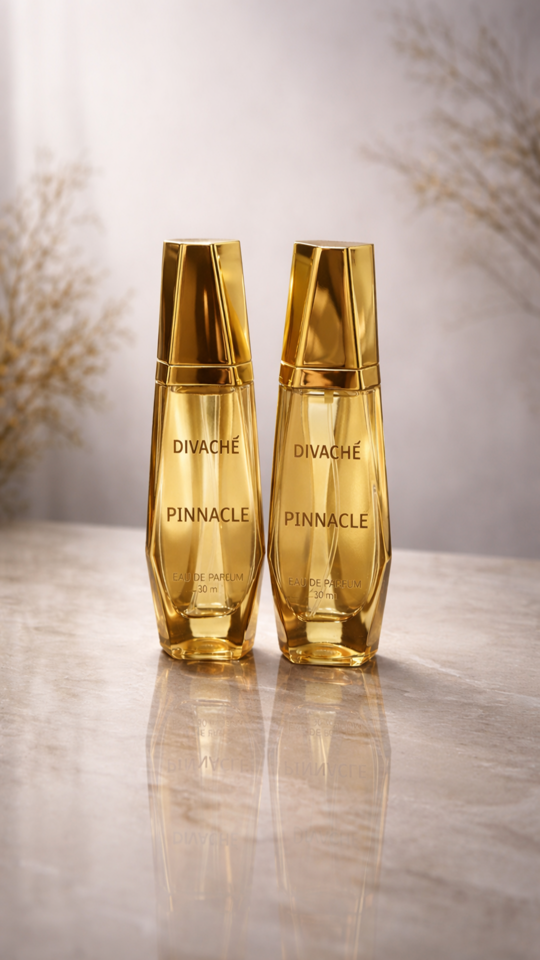 Two gold bottles of Divache Pinnacle on a reflective surface with a blurred background